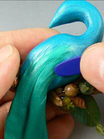 Blue and green clay being textured